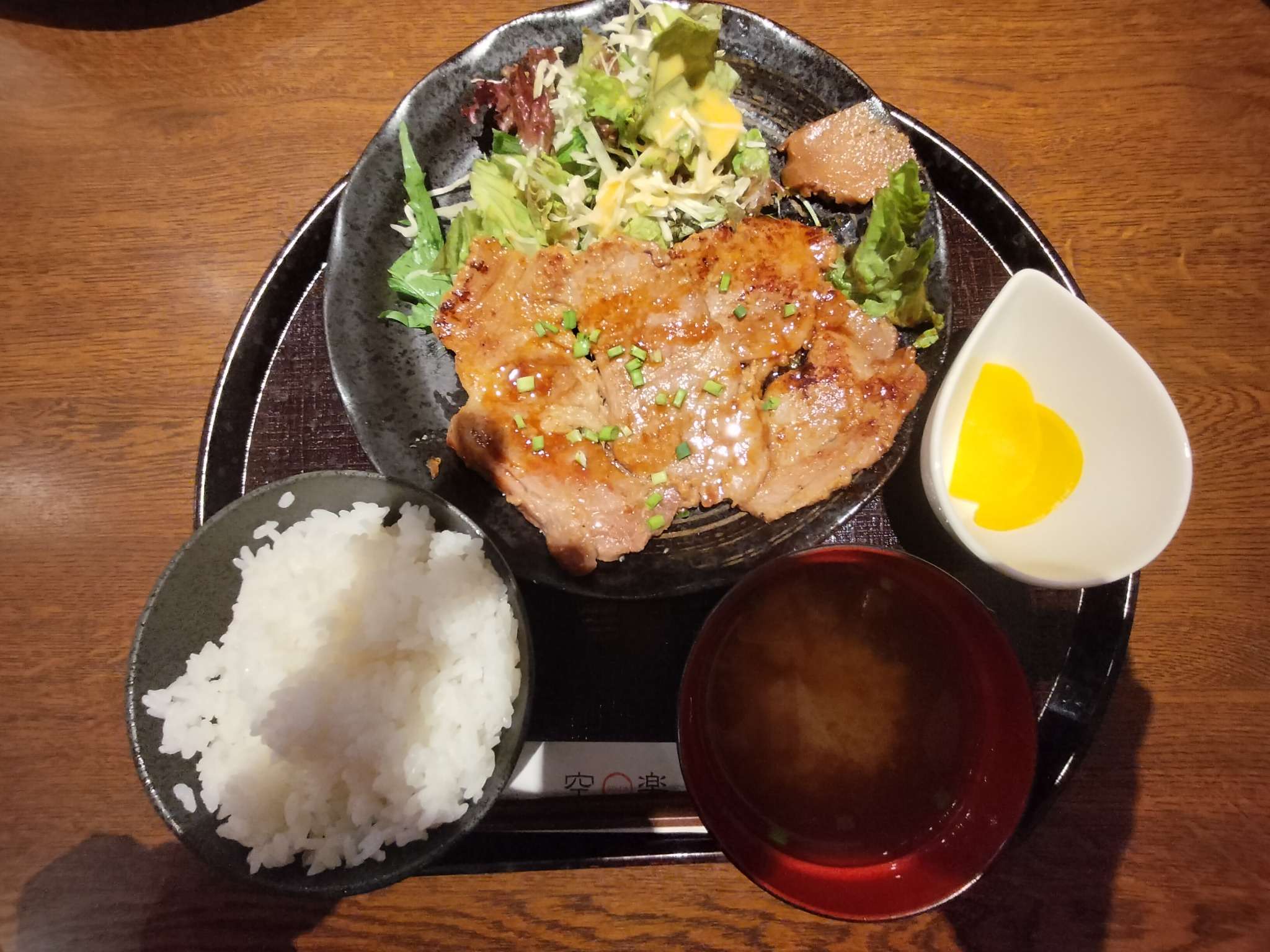 A Miso Pork set meal in Nagatoro, featuring grilled pork with miso glaze, steamed rice, salad, miso soup, and pickled radish.