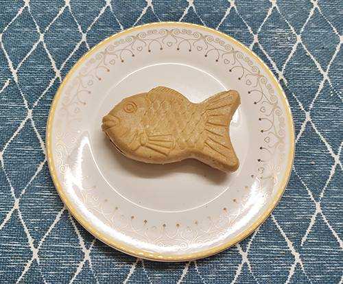 Taiyaki monaka ice cream on a plate, a Japanese fish-shaped dessert filled from head to tail